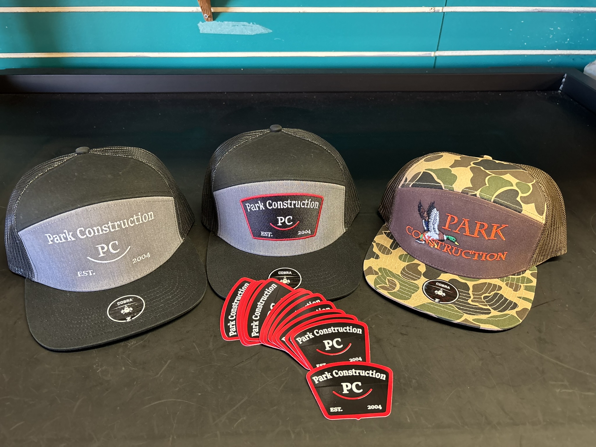 Custom die-cut stickers and embroidered caps